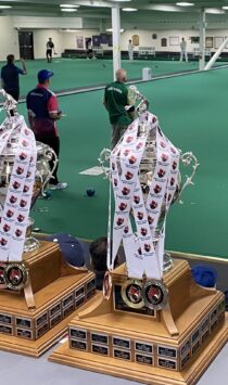 Medals draped over trophies